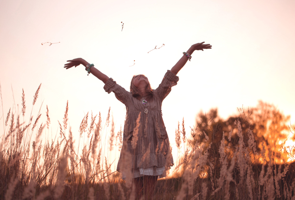 girl on meadow with sunset